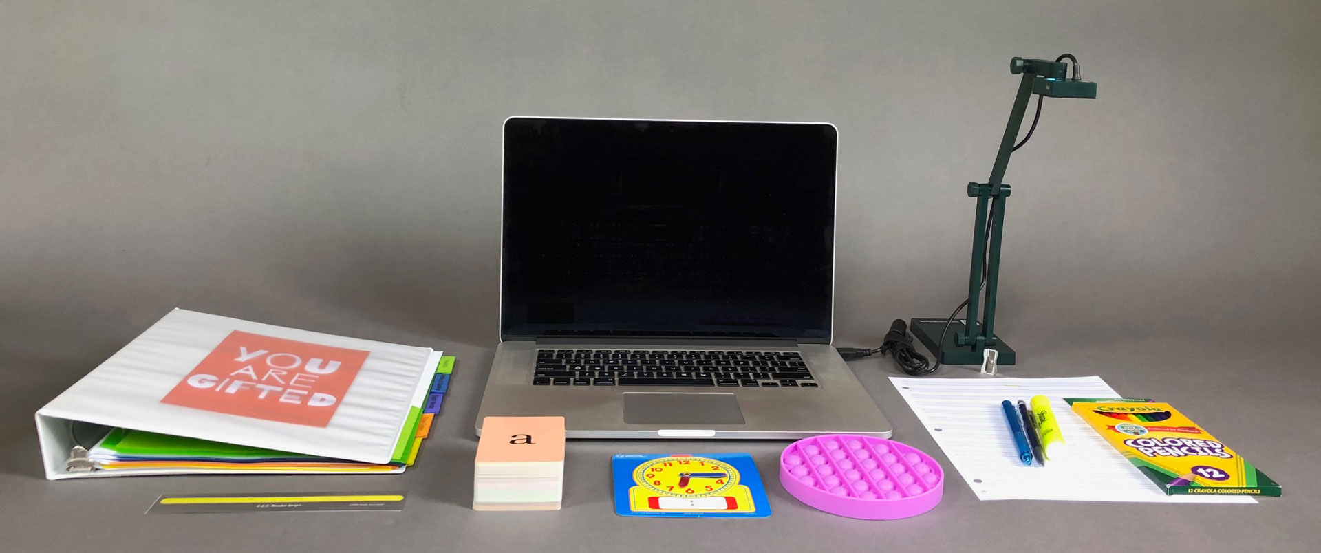 Our organization's equipment kit: curriculum binder, colored pencils, pens, poppit, adjustable clock face, notecards, overhead camera
